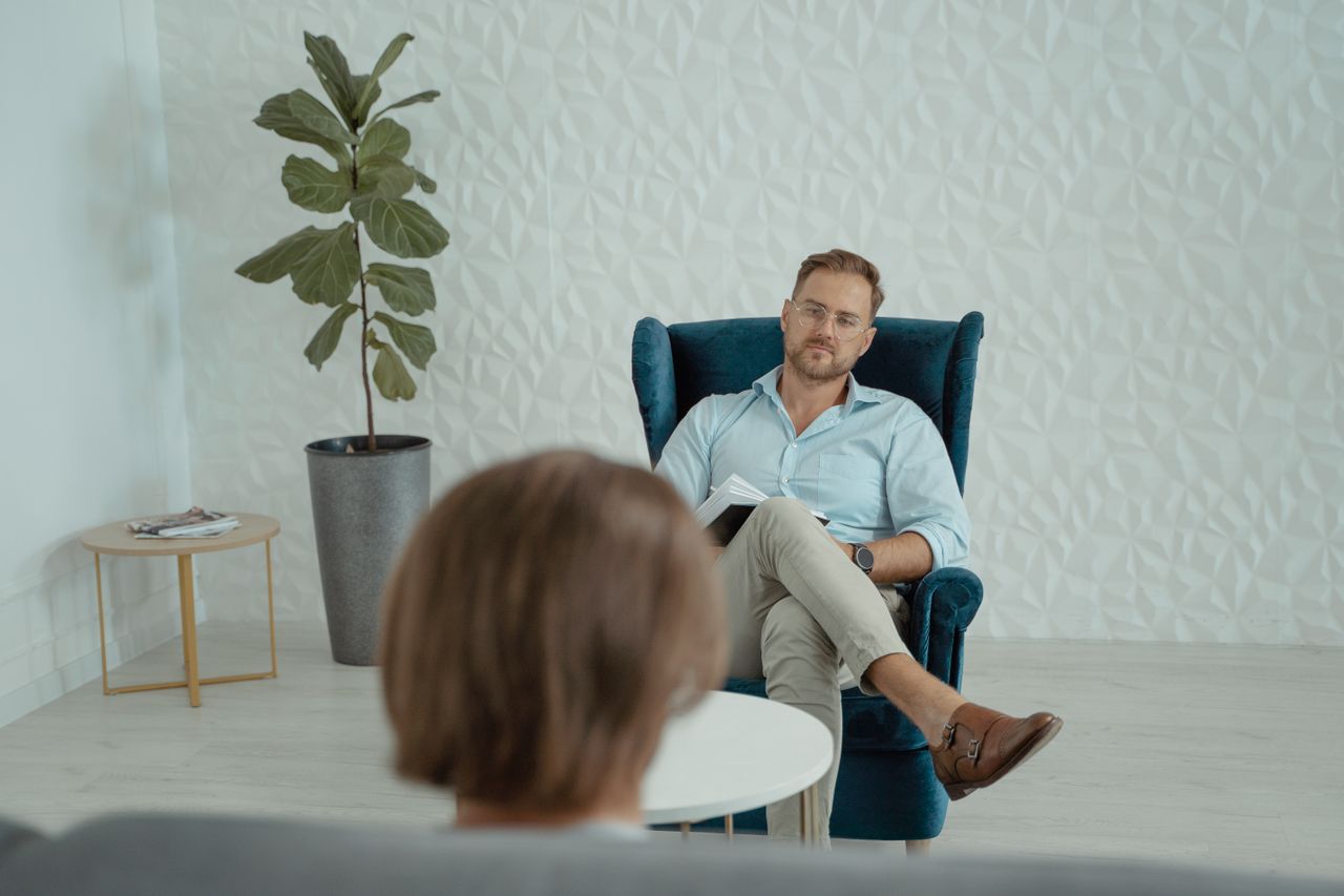Offerings A counseling session with a man sitting in a comfortable chair indoors.